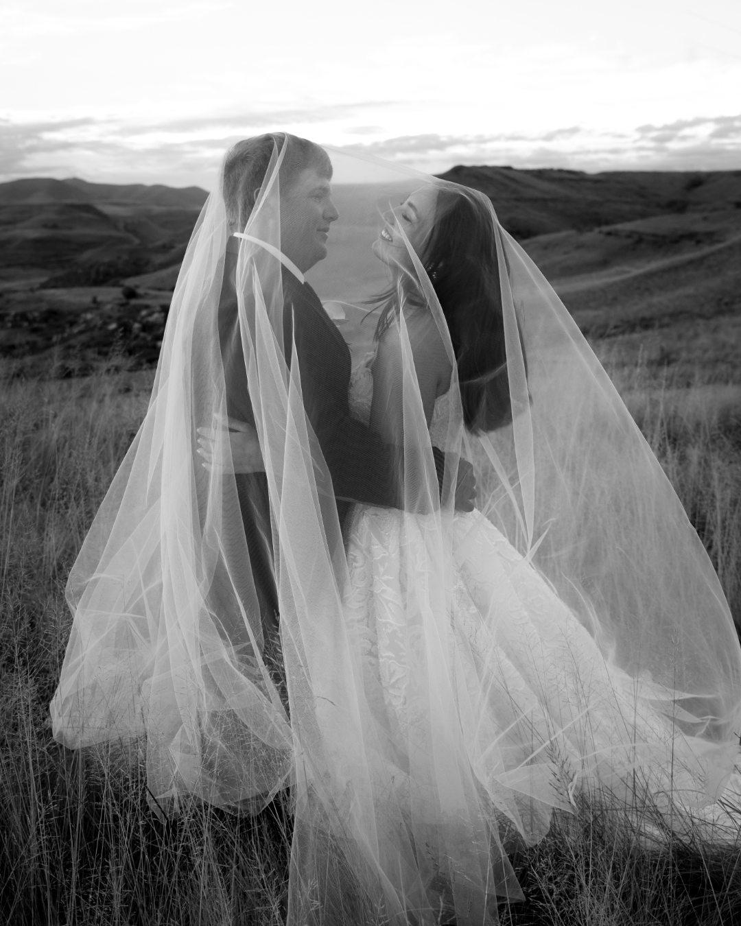 A bride and groom share an intimate moment under a flowing veil in South Africa